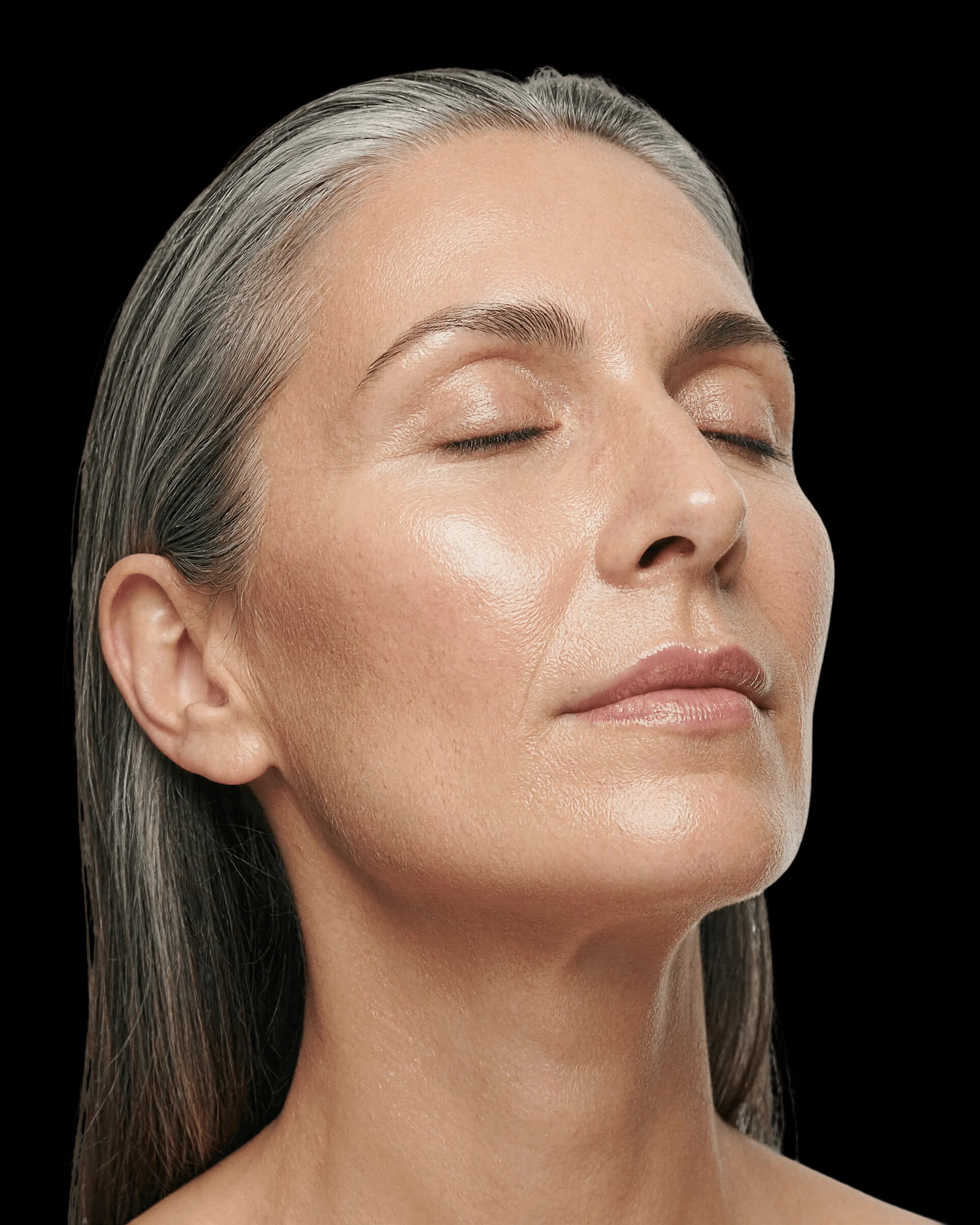 Woman with eyes closed experiencing menopause anxiety, brain fog, and fatigue